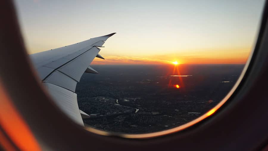 View of a sunrise looking out the window of a plane
