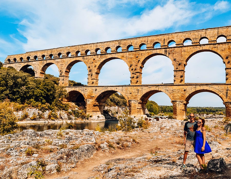 A couple poses in front of the spectacular Pont du Gard aqueduct