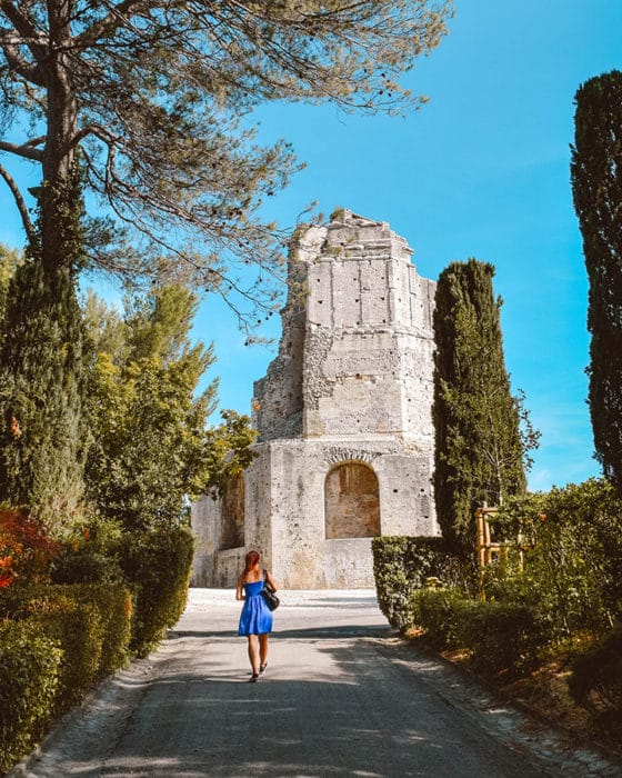 A girl walks toward La Tour Magne, Nimes France