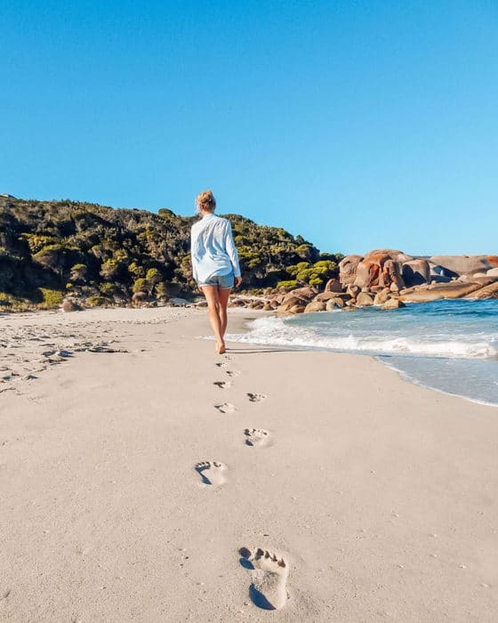 Girl walks alone on a beach
